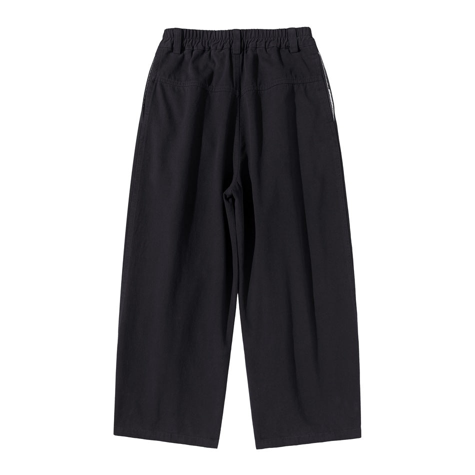 Back view of black wide-leg trousers with an elastic waistband and rear pockets.