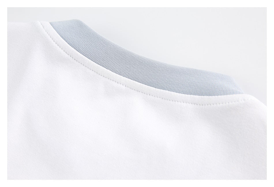 Close-up of a white garment neckline with a pale blue ribbed inner collar.