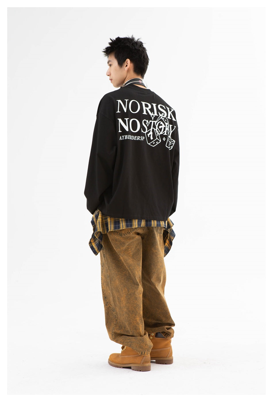 Rear view of a model wearing a black long-sleeve shirt with a large white dice graphic and lettering on the back.