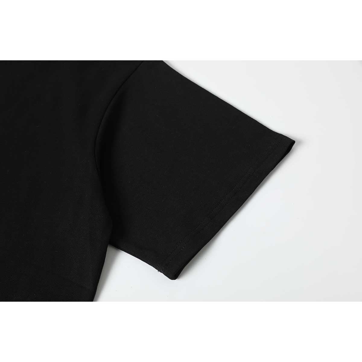 Close-up of a black T-shirt's short sleeve and stitched cuff.