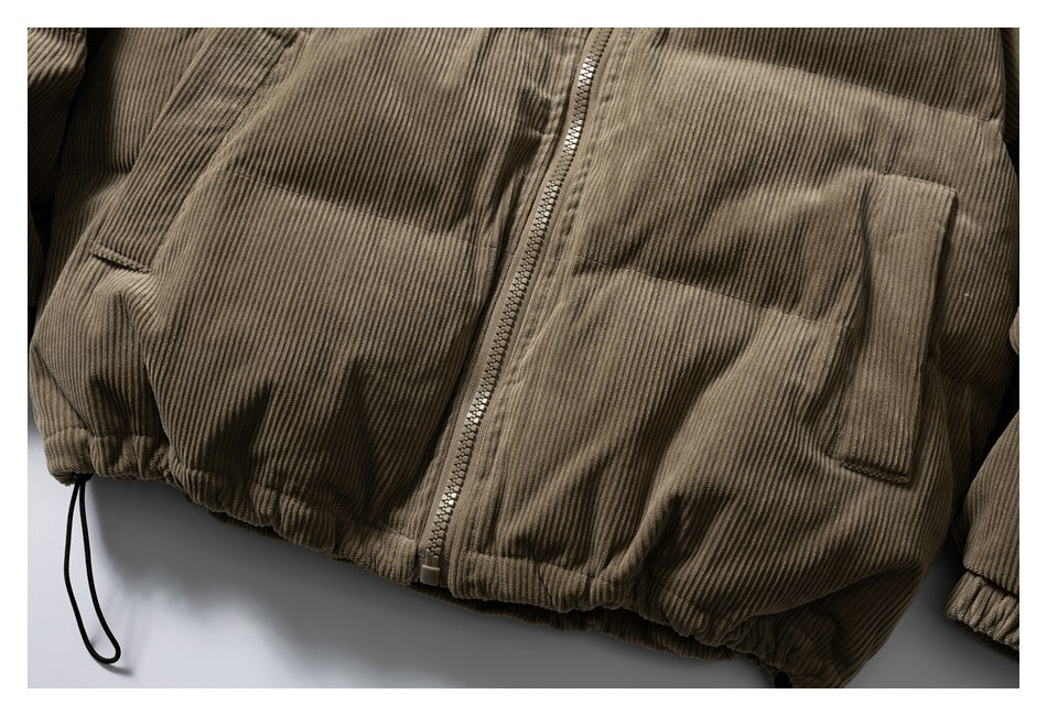 Close-up of the jacket's lower front, zipper, two pockets, ribbed texture and drawcord hem.
