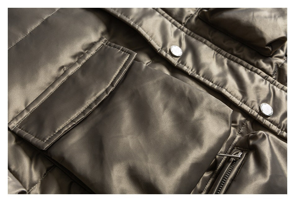 Close-up of taupe jacket pockets, snap-button front placket, and a vertical zipper.