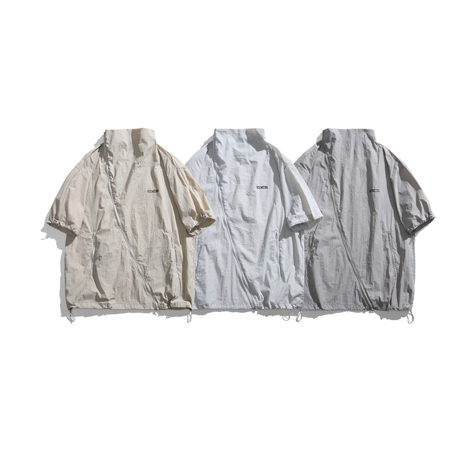 Three short-sleeve zip jackets shown together in beige, white, and light gray.