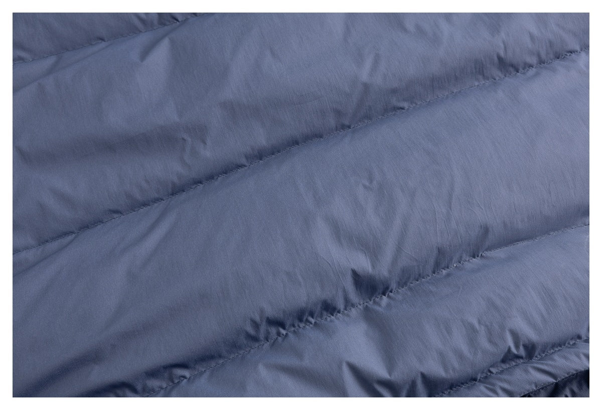 Close-up of blue padded fabric with diagonal stitched channels.