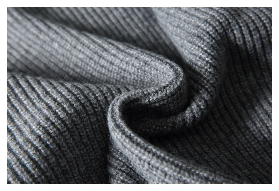 Close-up of folded gray rib-knit fabric showing its texture and edge.