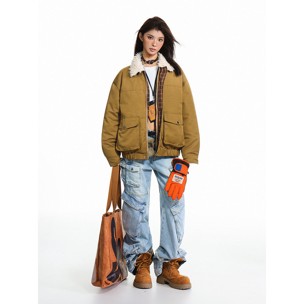 Full-length model wearing an open ochre jacket with a cream faux-fur collar, light-wash cargo jeans and brown boots.