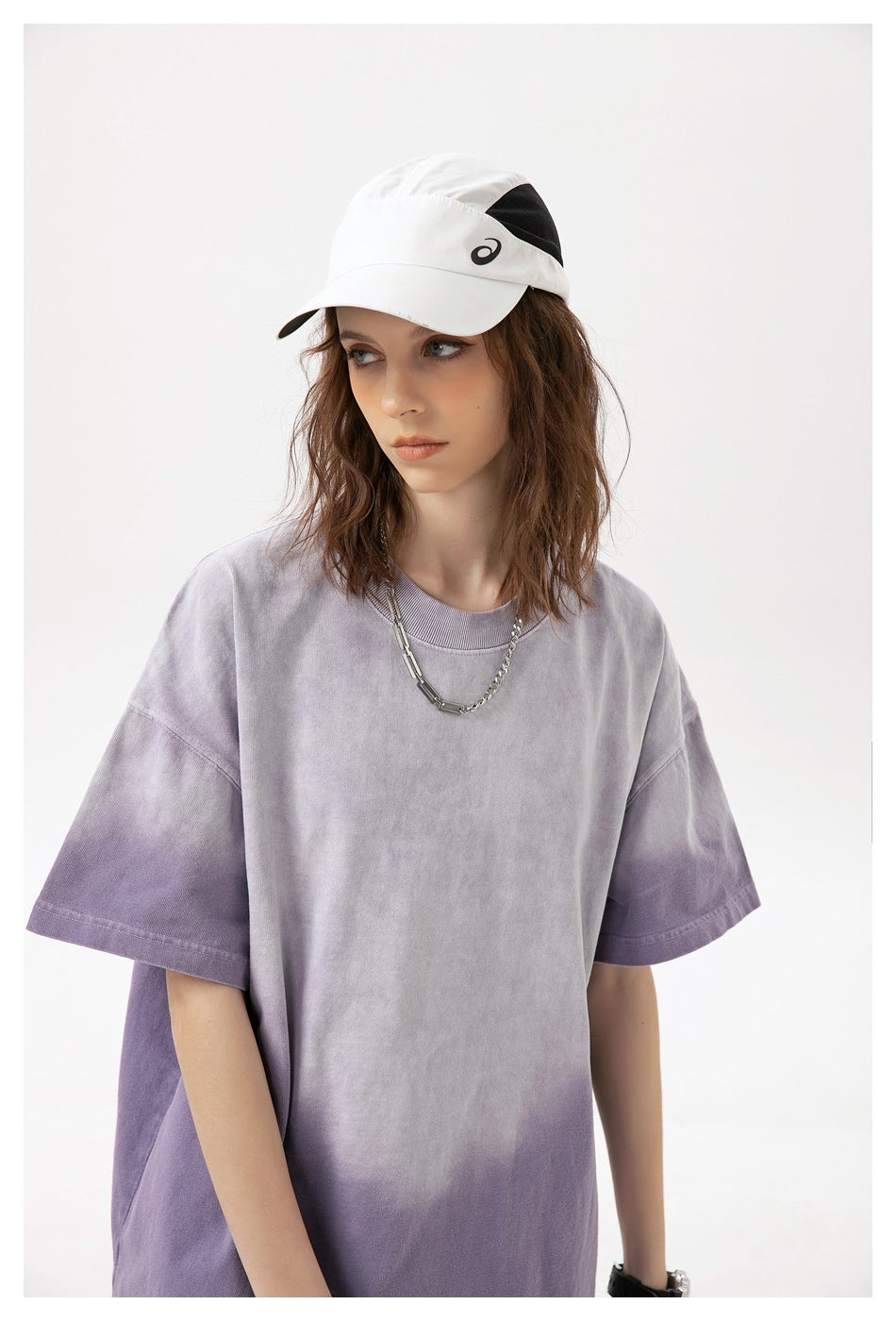 Close view of a model wearing a loose lavender and purple washed T-shirt, shown from the front.