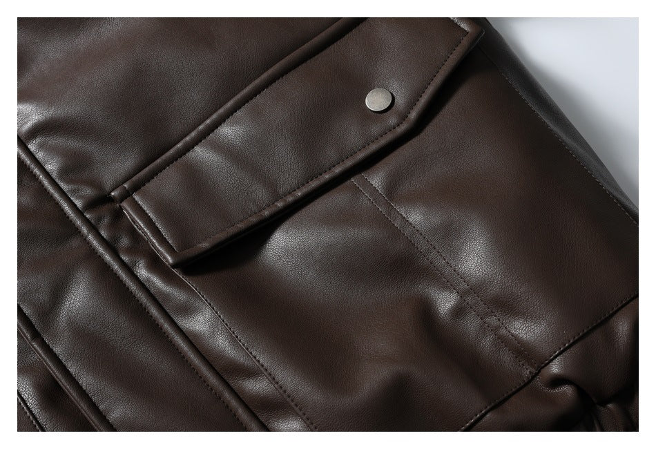 Close-up of the dark brown jacket's stitched pocket with a snap-fastened flap.