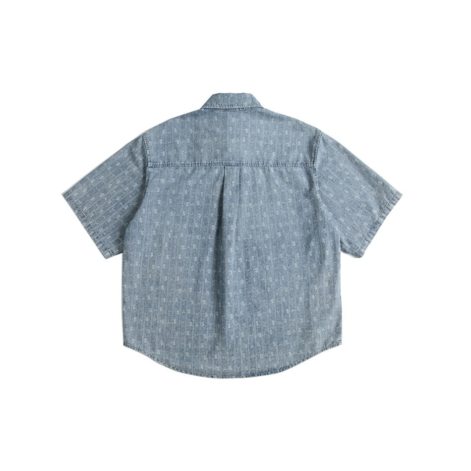Back view of denim-blue short-sleeve shirt with back yoke, center pleat and white striped motif pattern