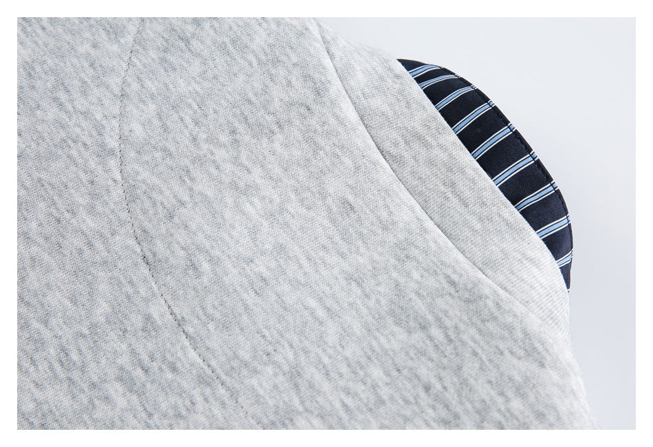 Close-up of light gray heather fabric beside a dark navy lining with thin blue and white stripes.