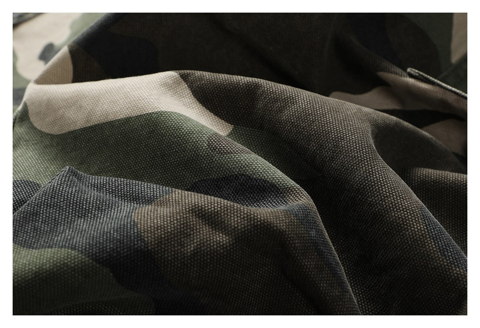 Macro view of the textured olive, black, and tan camouflage pants fabric.