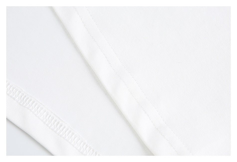 Close-up of the white shirt's hem and overlock stitching.