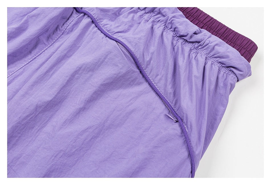 Close-up of lavender fabric with a diagonal purple zipper and a gathered elastic edge.