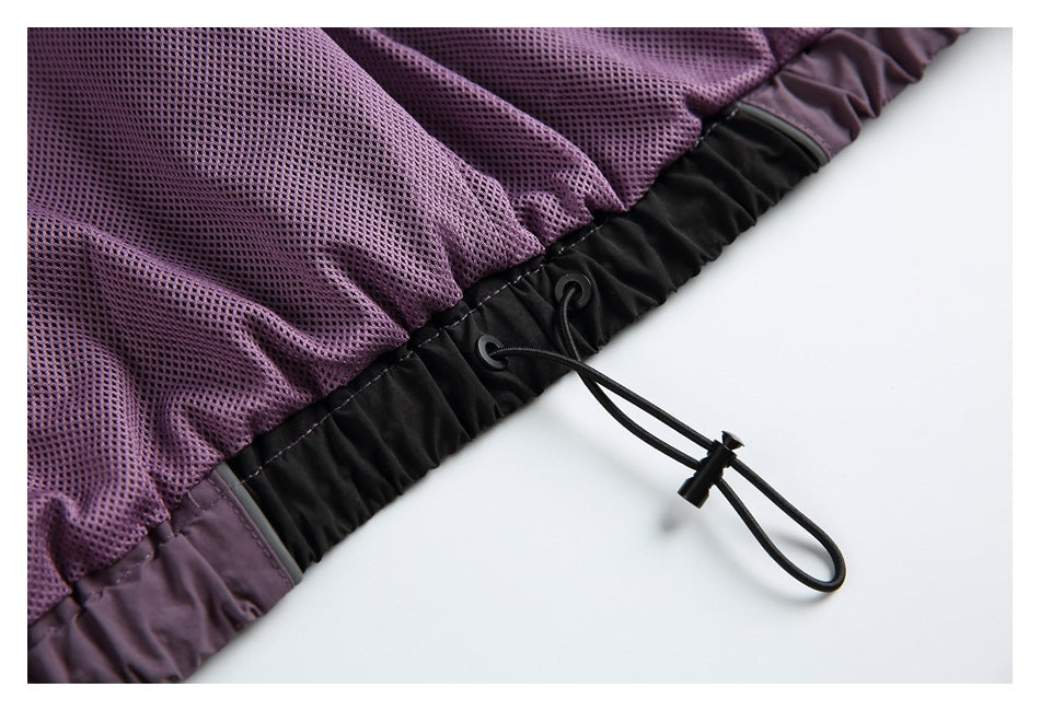 Close-up of purple mesh fabric and a black adjustable drawcord at the garment edge.
