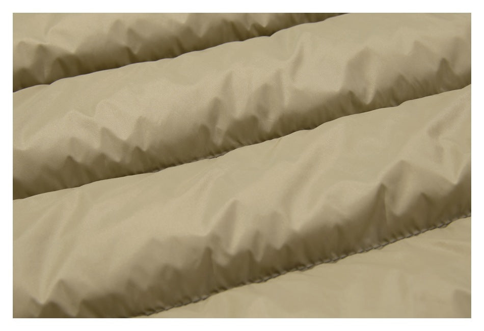 Close-up of the tan jacket's smooth padded sections and stitching.