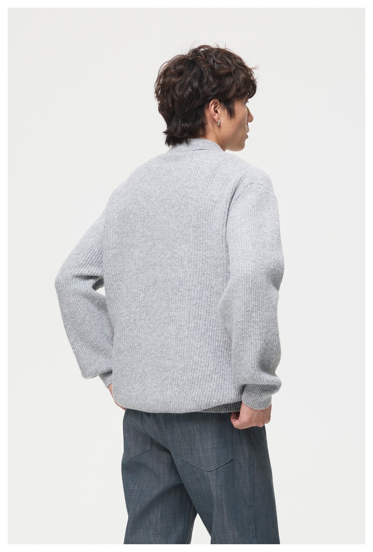 Model shown from behind wearing a light gray knit polo sweater with ribbed cuffs and hem.