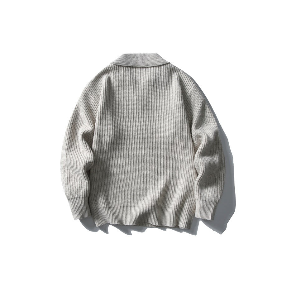 Back view of a light gray ribbed knit polo sweater laid flat on a white background.