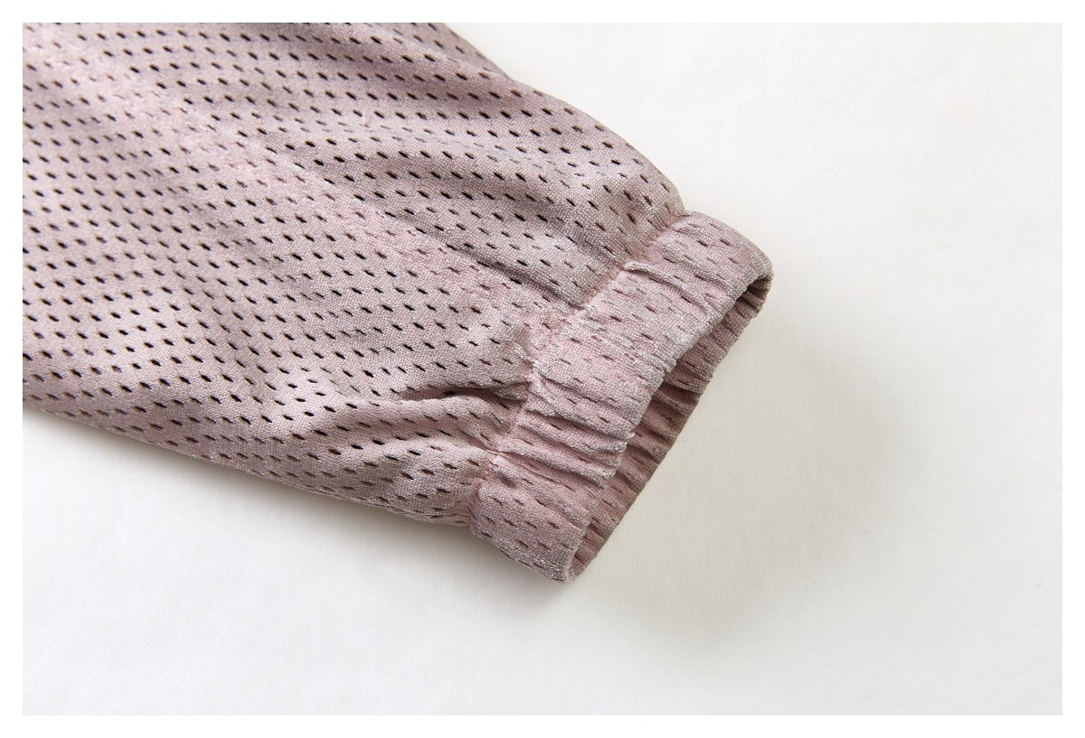 Pale mauve perforated sleeve ending in a gathered cuff, shown close up.