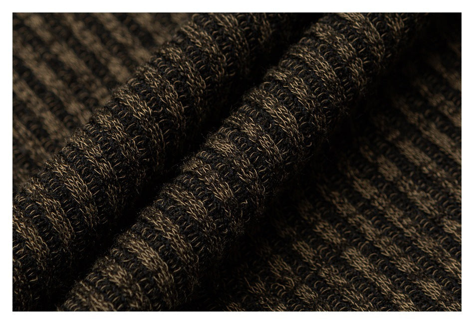 Close-up of dark brown and black marled knit fabric gathered into soft folds.