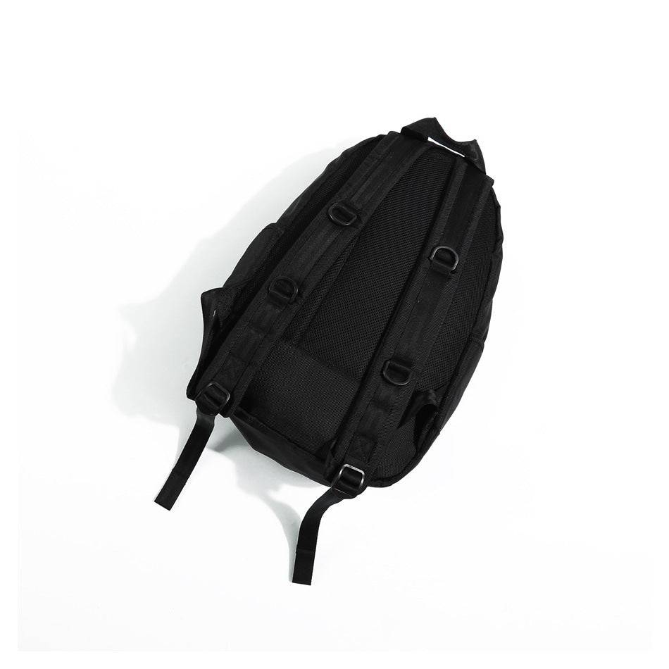 Back of black backpack with shoulder straps, D-ring attachment points and a mesh back panel