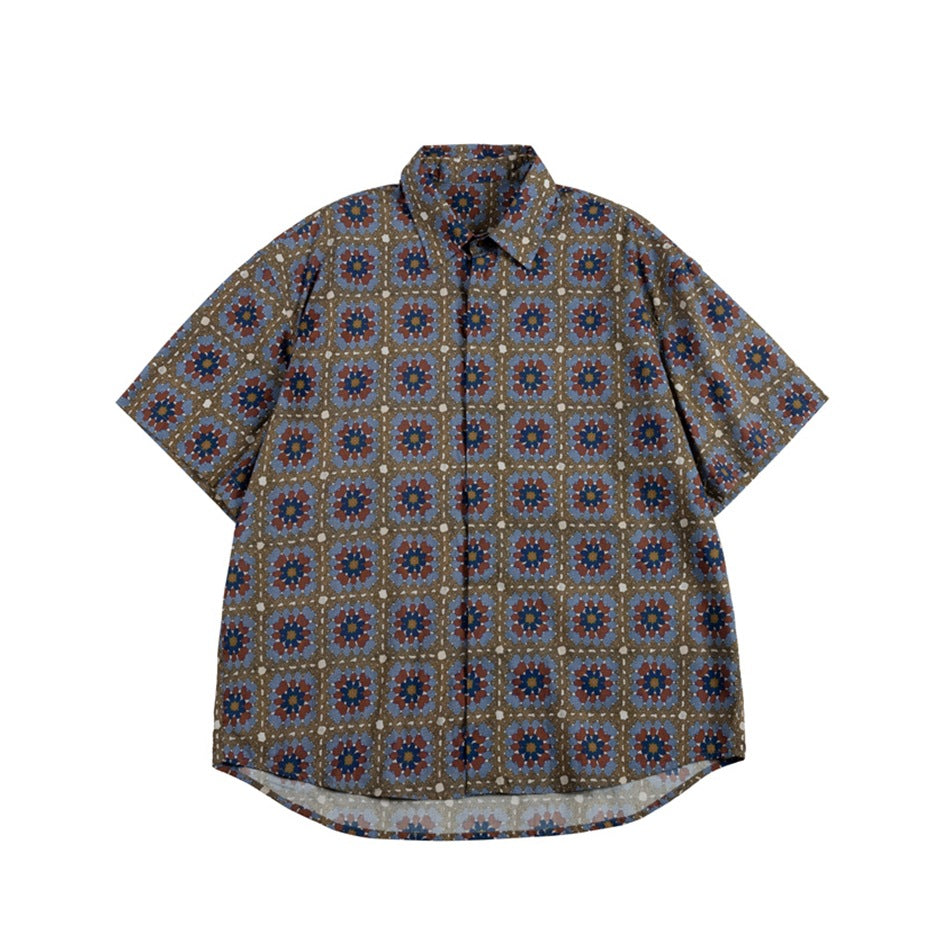Front of a short-sleeve collared shirt with a blue, rust and navy geometric floral print on olive brown