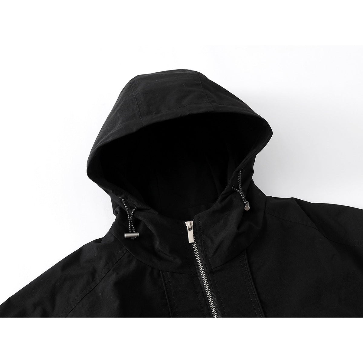 Close-up of a black hooded jacket showing the hood, drawcords, high collar and silver front zipper.