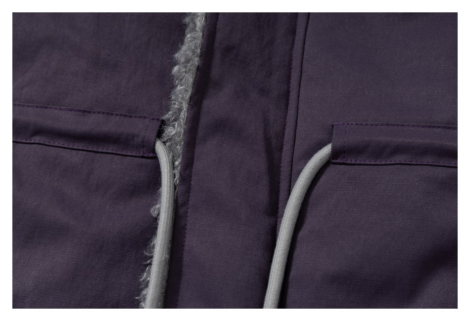 Close-up of a dark purple coat showing horizontal pocket openings, gray fuzzy trim, and light gray cords.