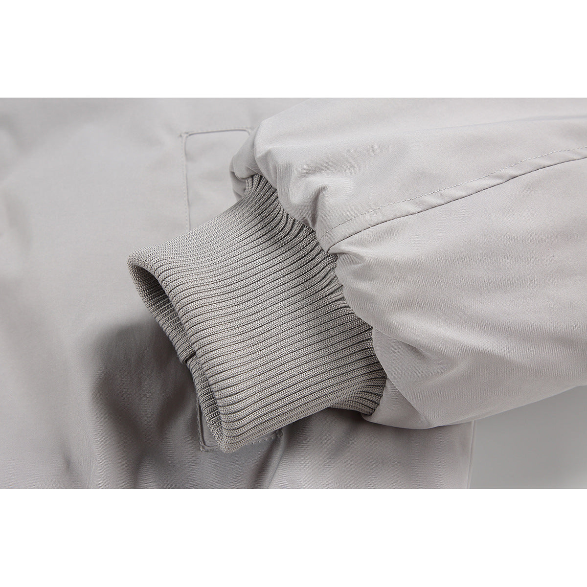 Close-up of a light gray jacket sleeve and ribbed cuff.