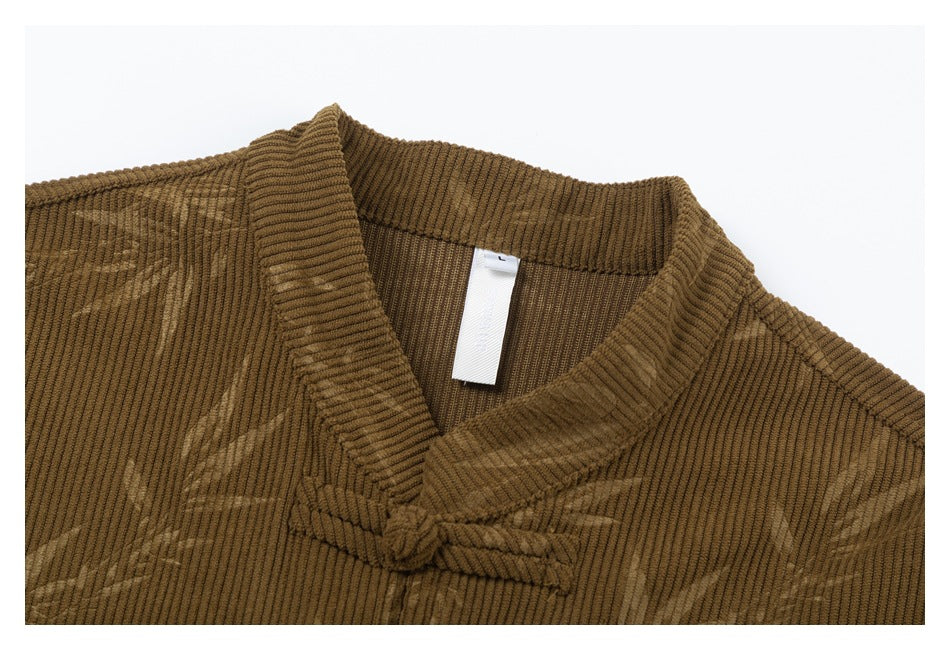 Close-up of the brown jacket's ribbed stand collar, frog closure, and bamboo pattern.