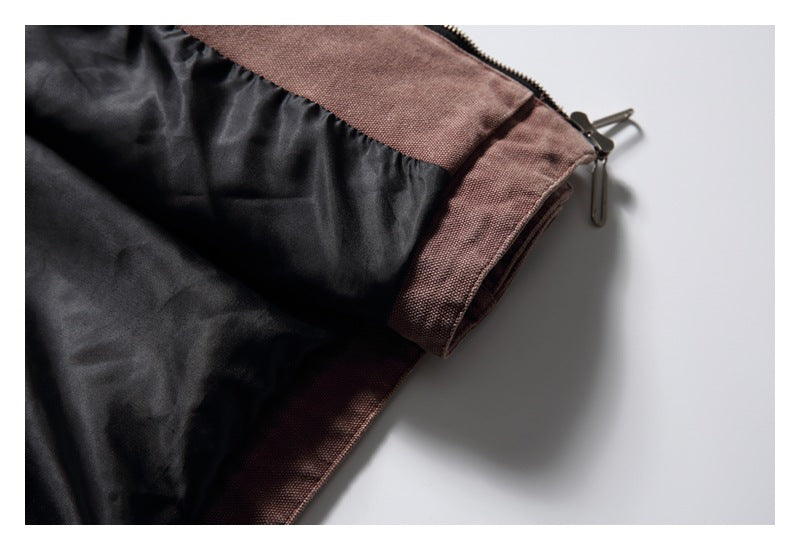 Close-up of the jacket's black lining and mauve-brown zipper edge.