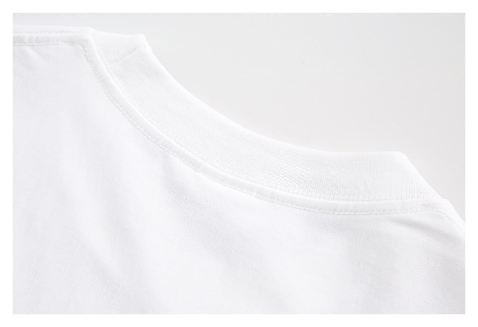 Close-up of the stitched crew neckline and shoulder seam on a white shirt.