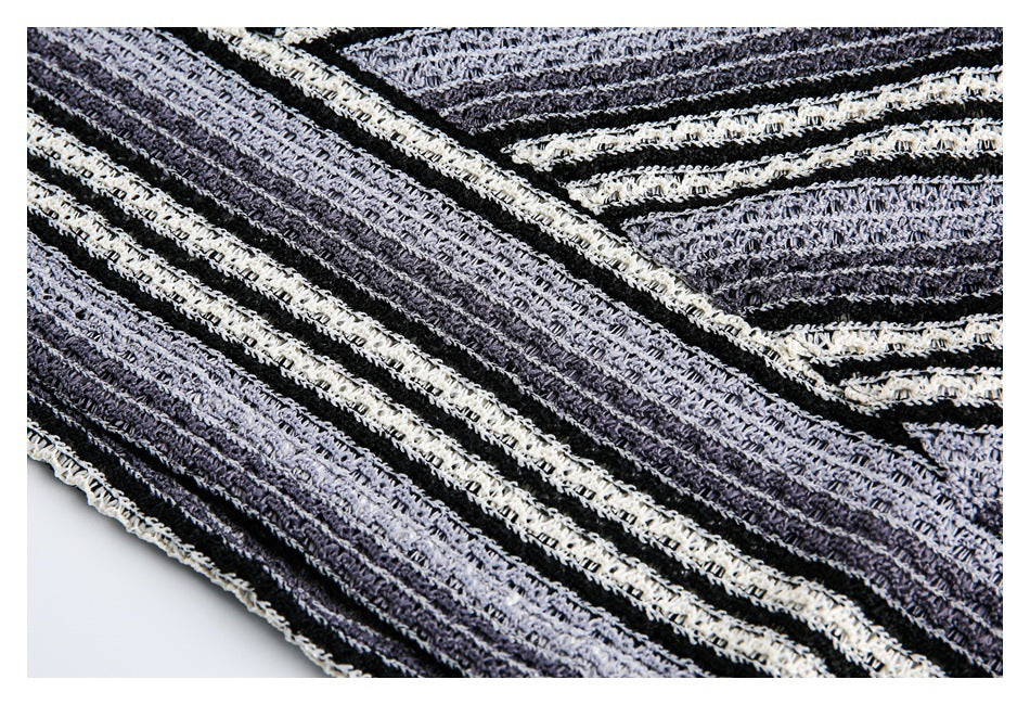 Close-up of the striped open-knit fabric and a finished edge in black, charcoal, and ivory.