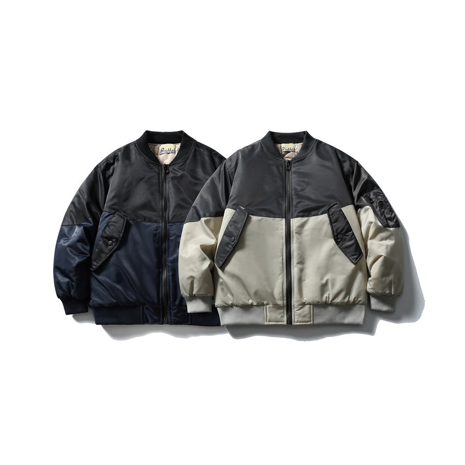Two front views of color-block bomber jackets: one black and navy, the other black and light gray.