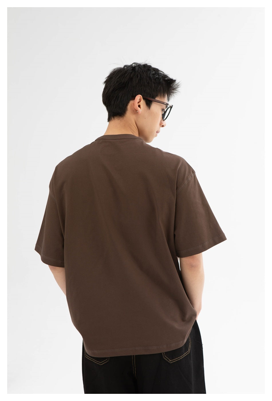 Model wearing a plain brown short-sleeve T-shirt, shown from the back against a white background.