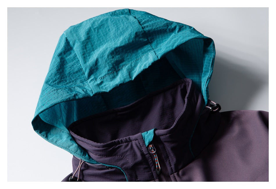 Close-up of the jacket's teal hood, dark purple collar, and drawcord details.