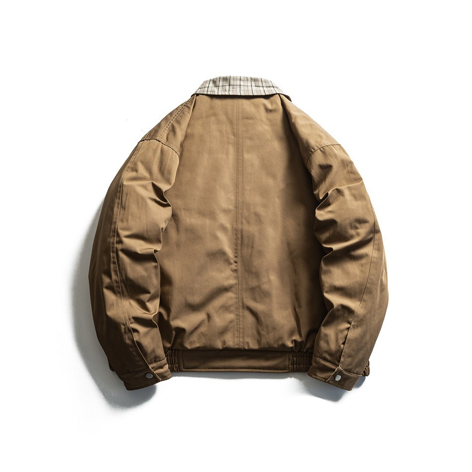 Back view of a tan jacket laid flat, with a plaid collar, gathered hem, and snap-tab cuffs.