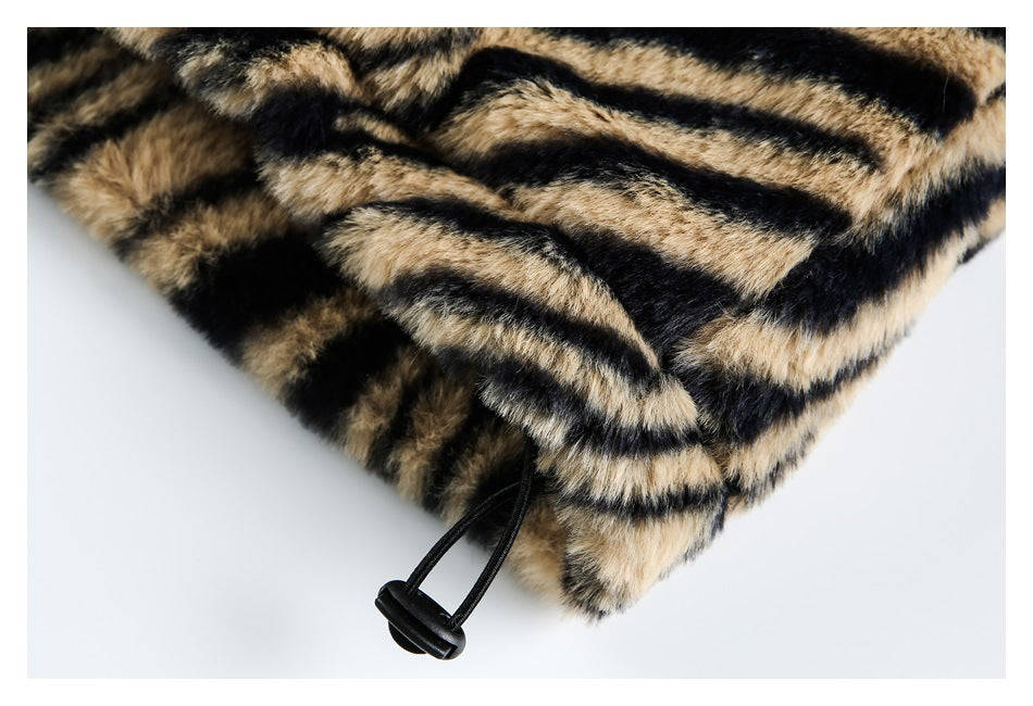 Close-up of the garment's tiger-striped plush hem with a black elastic cord and toggle.