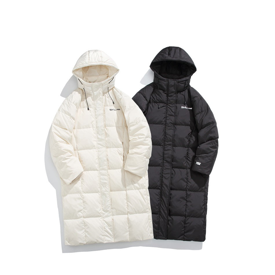 Long hooded puffer coats shown together in ivory and black.