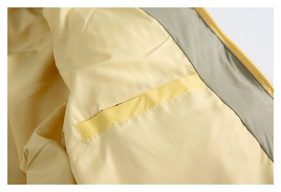 Close-up of the jacket’s interior, showing a small yellow pocket and gray lining.