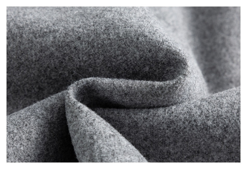 Close-up of folded gray fabric showing its soft, mottled surface and thickness.