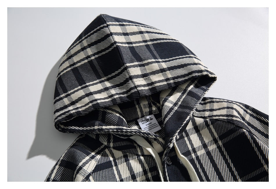 Close-up of the plaid hood and neckline, with a small sewn-in label and part of the button front visible.