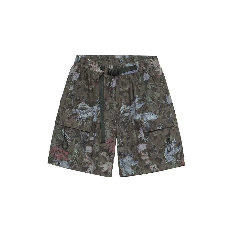 Front of green camouflage floral print cargo shorts with black belt, elastic waist and flap pockets with toggles