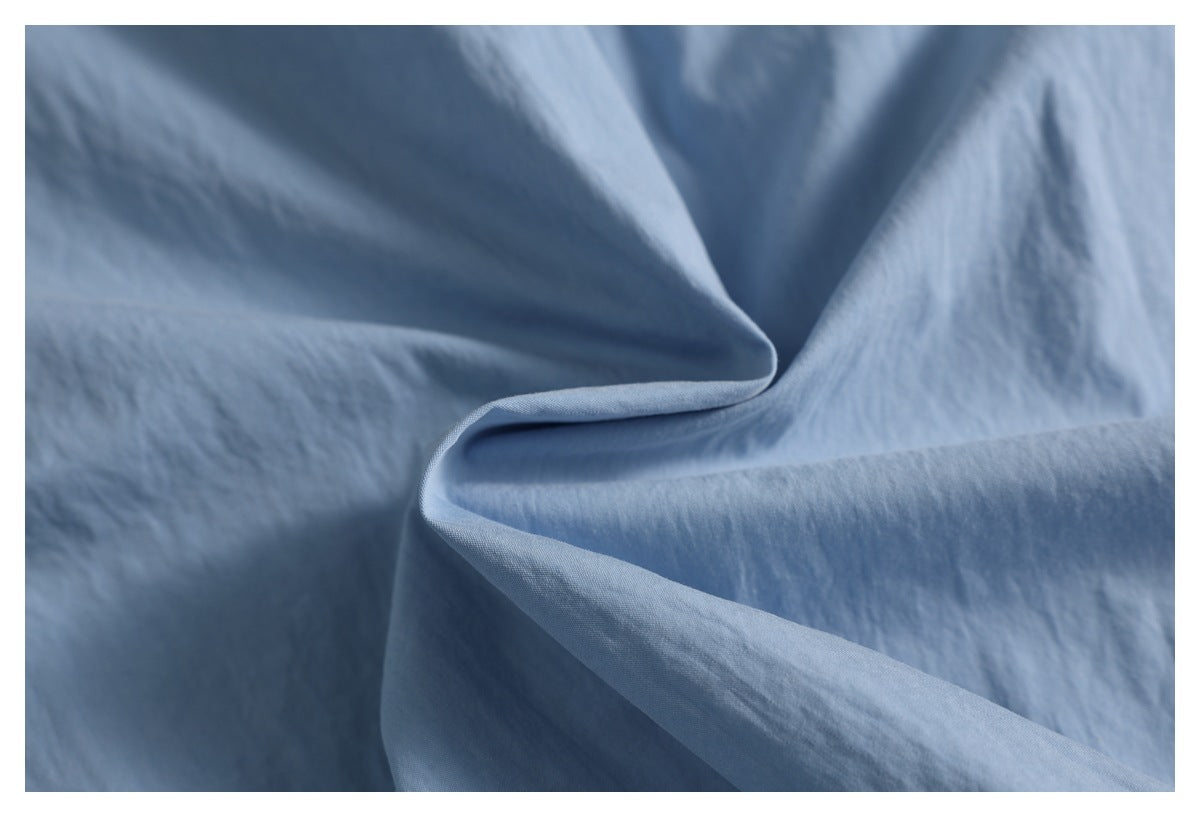 Close-up of softly draped blue fabric with a subtle visible weave.