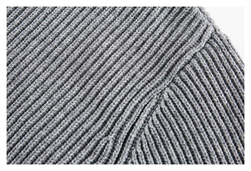 Close-up of the gray sweater's ribbed knit and shoulder seam.