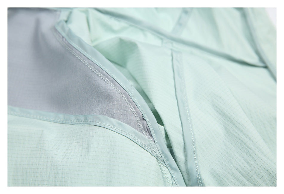 Close-up of pale mint garment seams and gray inner lining.