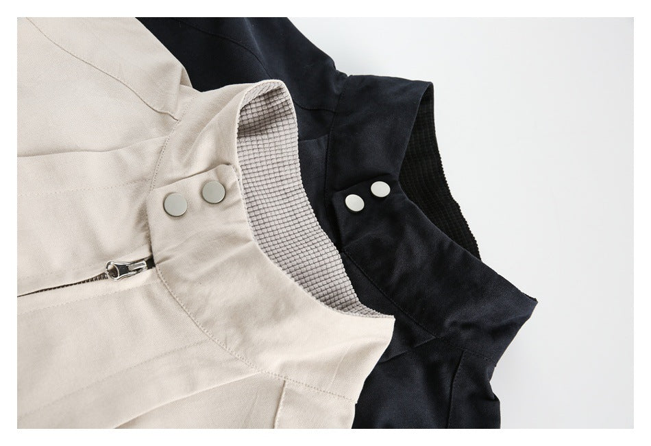 Close-up of off-white and black jacket collars, showing snap buttons, zipper details, and textured inner fabric.