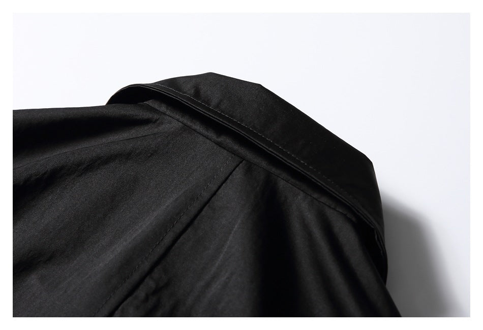 Close-up of the black garment's back shoulder and collar seam.