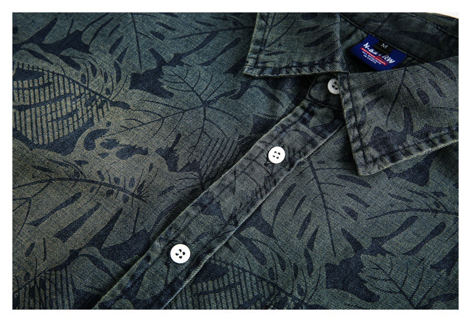 Close-up of the leaf-print shirt's white buttons, front placket, and collar label.