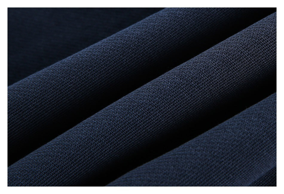 Macro view of the textured knit surface of dark navy fabric in folds.