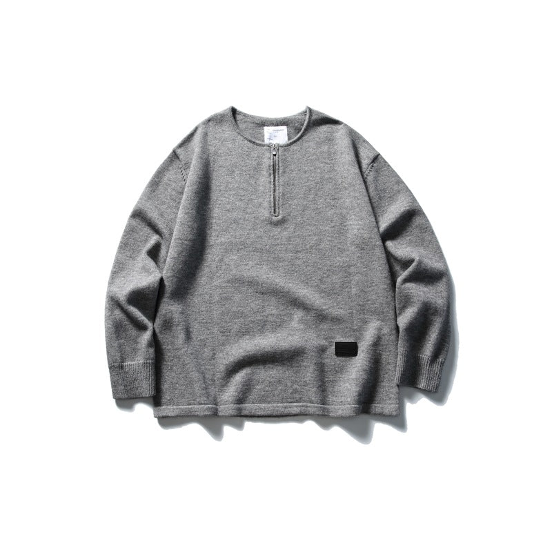 Gray knit half-zip pullover sweater with ribbed cuffs and small black hem patch, flat lay front view